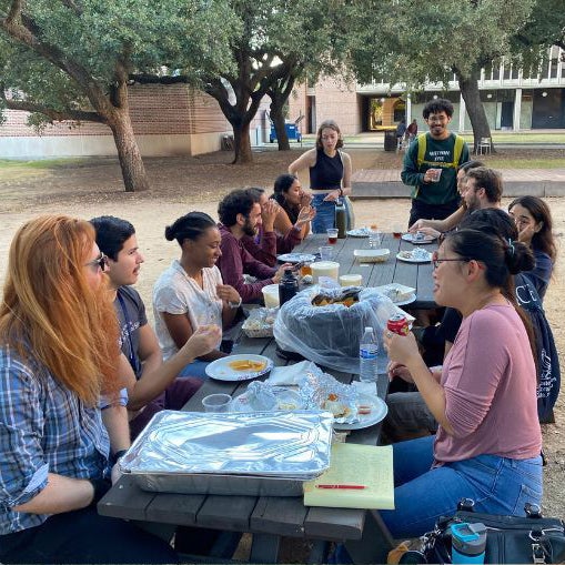 group of students sit at picnic table