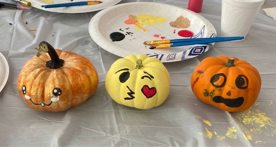 3 pumpkins with painted facial expressions